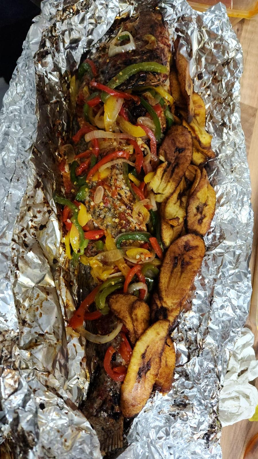 Whole grilled fish with charred peppers and fried plantain — the Rosies feast